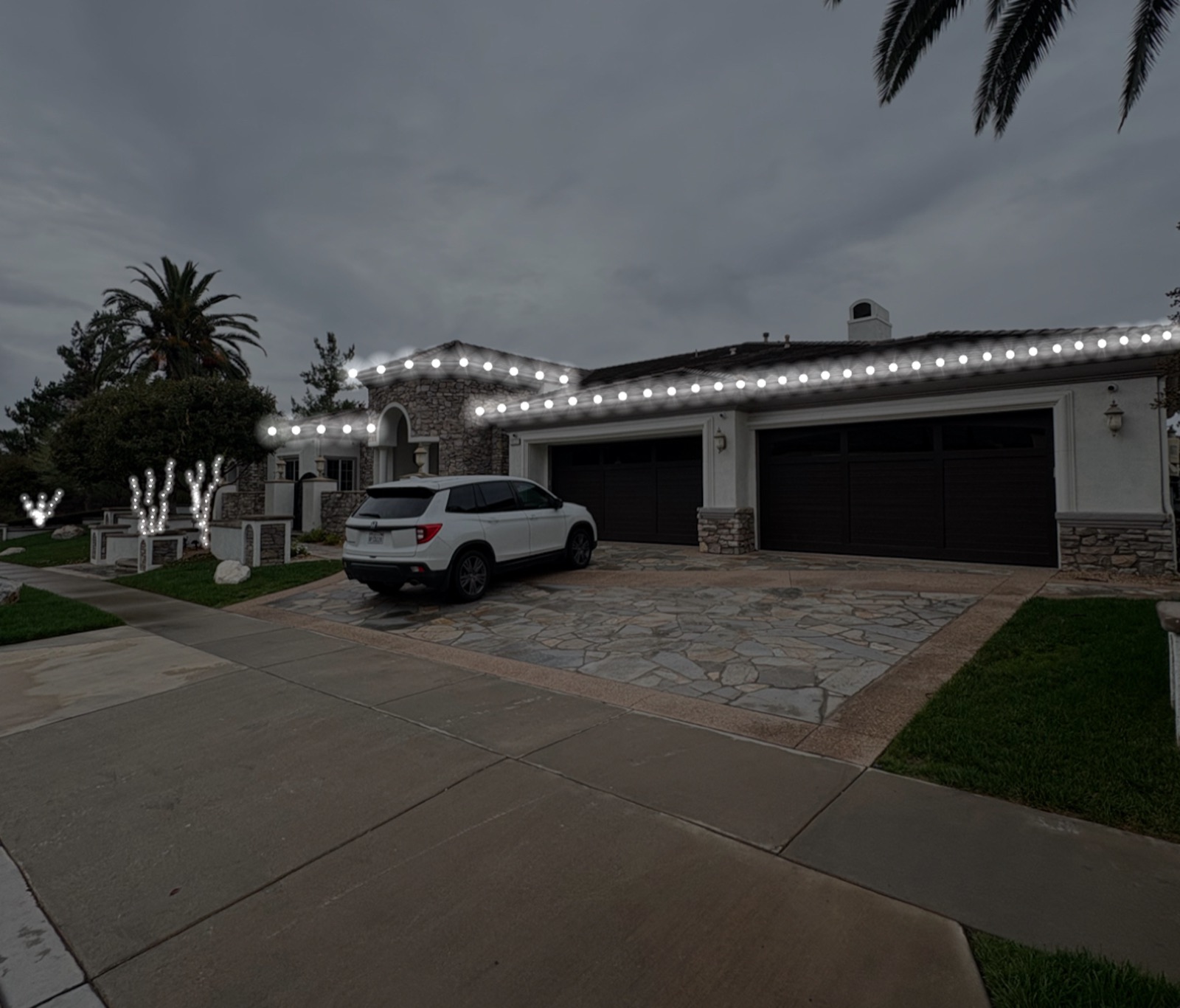 Estate lit by Hanson Holiday Lighting at twilight