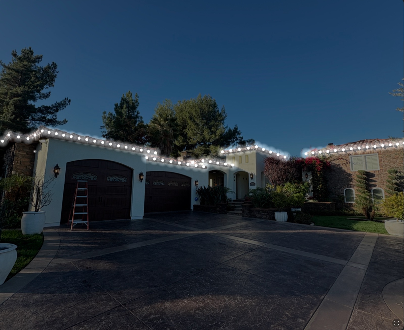 Tile-roof home with warm-white roofline at blue-hour